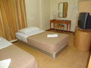 Postel nebo postele na pokoji v ubytování Pristine Hotel