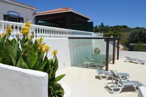 a patio with lounge chairs and a house at Boa Vista in São Bartolomeu de Messines