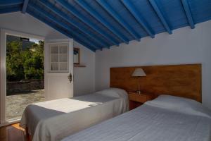 Cama ou camas em um quarto em Casa de Pedra