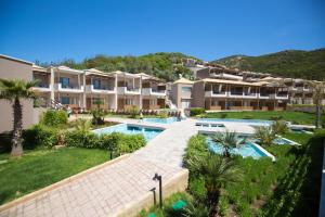 an apartment complex with a swimming pool and a resort at Thassos Grand Resort in Alyki