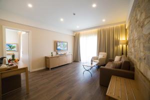 a living room with a couch and a table at Thassos Grand Resort in Alyki