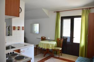 a kitchen with a table with a yellow table cloth at Apartments Bakuk in Stari Grad