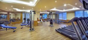 a gym with treadmills and machines in a room at Armada Living - Holiday Homes Rental in Dubai