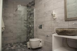 a bathroom with a toilet and a sink at Popi Studios in Arkasa