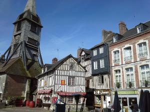 a group of buildings with a clock tower at Mansion Victorine in Honfleur