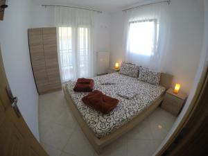 Postel nebo postele na pokoji v ubytování Dimi Apartments