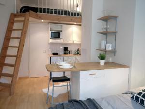 a small kitchen with a table in a tiny apartment at 2ndhomes Kamppi Apartments 2 in Helsinki