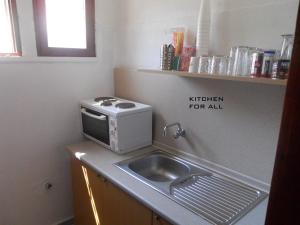 a kitchen with a sink and a microwave at Prinos Mare in Prinos +25 photos