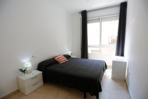 Posteľ alebo postele v izbe v ubytovaní Apartaments Claudia