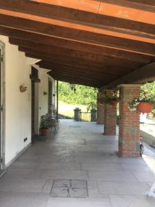 an outdoor patio with a wooden roof and a brick pillar at Cinque Terre Experience by Amedeo in Piano di Follo