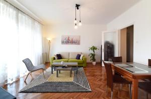 a living room with a couch and a table at Apartment Sunny, Zagreb City Center in Zagreb