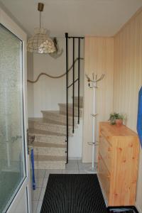 a hallway with a stairway with a set of stairs at Zur Schatztruhe in Nordstrand