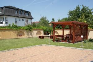 a park with a picnic table and a wooden pavilion at Mara Apartman in Sárvár