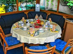 a dining room table with a plate of food on it at Pension Wehner in Torgau