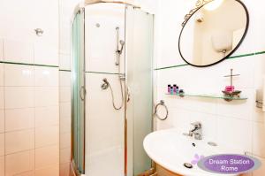 a bathroom with a shower and a sink and a mirror at Dream Station in Rome