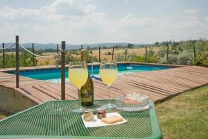 einen Tisch mit zwei Gläsern Wein und einem Teller Essen in der Unterkunft B&B Il Pettirosso di Siena in Siena