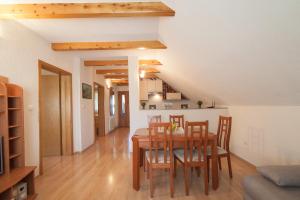 a kitchen and dining room with a table and chairs at Apartmant & Room Bruna in Drežnik Grad