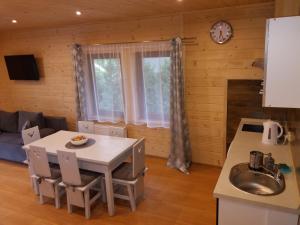 a kitchen and dining room with a table and a sink at Sebahouse in Zakopane