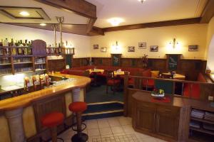 a restaurant with a bar and some tables and chairs at Gasthof & Appartementhaus Meyer in Annaberg