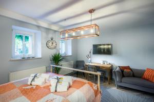 a bedroom with a bed and a living room at Sea Sail Apartments in Sopot