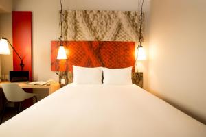 a bedroom with a large bed with two white pillows at ibis Lima Reducto Miraflores in Lima