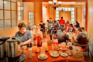 a group of people sitting at tables in a restaurant at Hotel Monserrat in Cochabamba