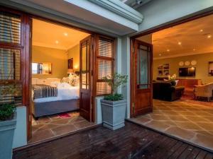 a bedroom with a bed and a living room at 11 Protea in Knysna