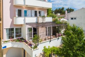 an apartment building with flowers on the balconies at House Coko in Baška Voda
