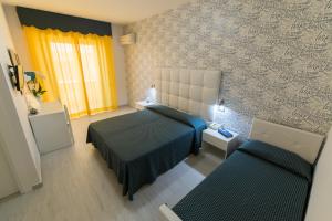 Postel nebo postele na pokoji v ubytování Nelson Hotel + 37 fotografií