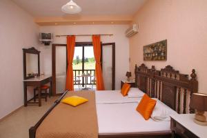 a bedroom with a bed and a desk and a balcony at Maria Studios in Neo Klima