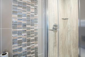 a shower with a glass enclosure in a bathroom at Brighton House in Brighton & Hove