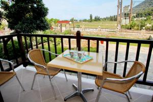 a table and chairs on a balcony with a view at Maria Studios in Neo Klima