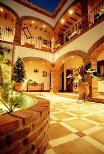 an indoor courtyard with a pool in a building at Hotel Rural Andalucia in Sierra de Yeguas