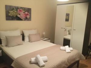 a bedroom with a bed with two towels on it at Holiday Home Villa Romantica in Sveti Filip i Jakov +34 photos