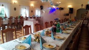 une longue table avec des assiettes de nourriture dans l'établissement Zbójna Debra, à Golejów