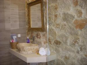 a bathroom with a sink and a mirror at Seascape Apartment in Faliraki