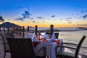 a table set up on the beach at sunset at Simpson Bay Resort Marina & Spa in Simpson Bay