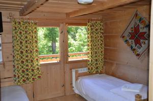 a bedroom with two beds in a log cabin at Willa Śmiechówka in Kościelisko