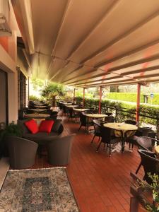 an outdoor patio with tables and chairs and tables at Hotel Anna in Malcesine