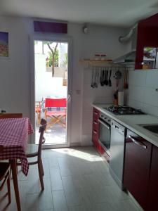 a kitchen with a table and a view of a patio at Apartman Nora in Hvar