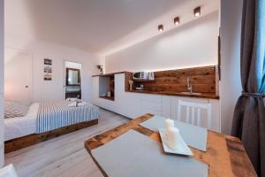 a bedroom with a bed and a table with a sink at Apartments Sole in Komiža