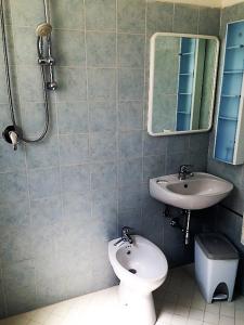 a bathroom with a toilet and a sink at Hotel Madrid in Riccione