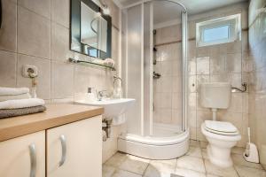 a bathroom with a toilet sink and a shower at Villa Kamenica in Komiža +55 photos