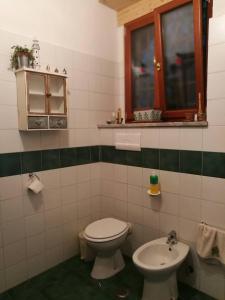 a bathroom with a toilet and a sink at Garden Bijou with Sea View in Vietri sul Mare