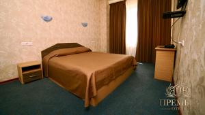 En eller flere senger på et rom på Premier Hotel Center