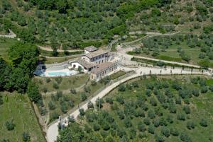 an aerial view of a large house with a road at Pucci Country House in Ferentillo