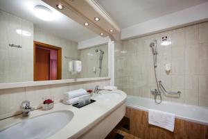a bathroom with a sink and a shower and a tub at Hotel Excelsior - Liburnia in Lovran +37 photos