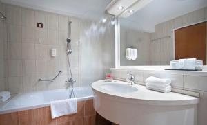 a bathroom with a sink and a shower and a tub at Hotel Excelsior - Liburnia in Lovran