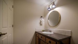a bathroom with a sink and a mirror at Eagle Cap Chalets in Joseph