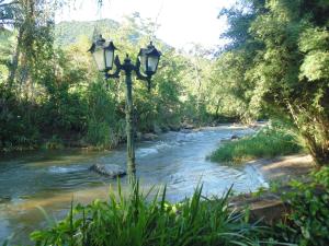 a street light in front of a river at Repousada Sana in Sana